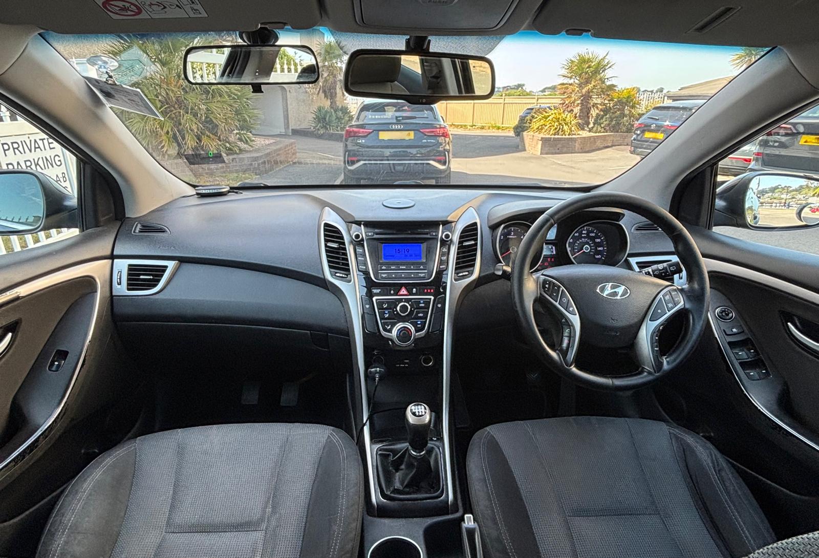 Inside CP Driving's dual-control manual car — gearstick, clutch pedal and dashboard